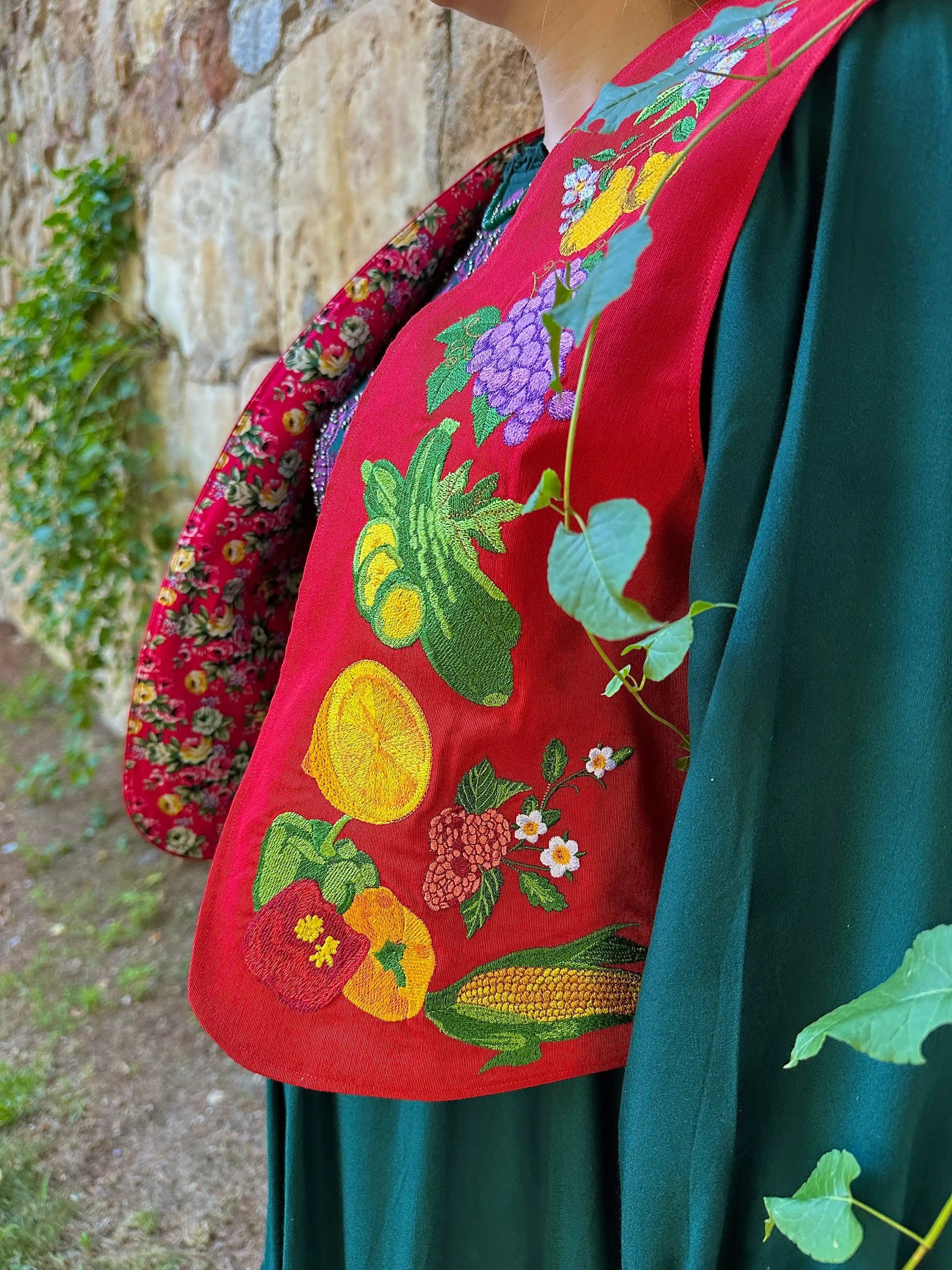 Traditional embroidered garment with colorful designs against a natural background