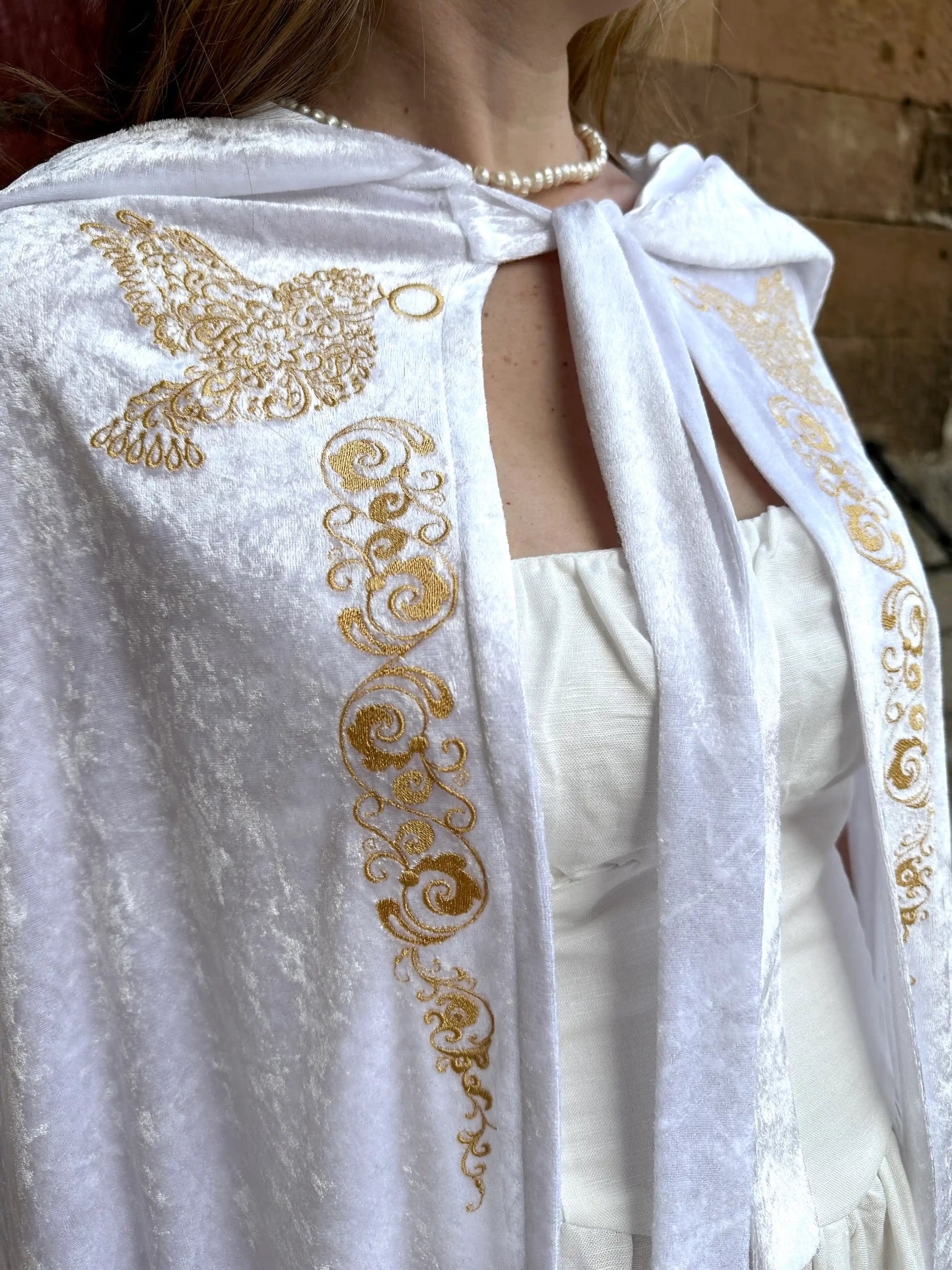 White garment with gold embroidery on a blurred background